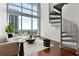 Bright living room with modern furniture, spiral staircase, and floor-to-ceiling windows with a stunning view at 150 E Robinson St # 1011, Orlando, FL 32801
