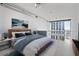 Bright main bedroom featuring large windows, a modern bed frame, and stylish decor at 150 E Robinson St # 1011, Orlando, FL 32801