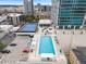 Aerial view of resort-style pool, tennis court, and parking at 150 E Robinson St # 1011, Orlando, FL 32801