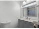 Bathroom with gray vanity, marble countertop, and shower at 1527 Hernandes Dr, Orlando, FL 32808