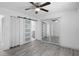 Bedroom with gray flooring, ceiling fan, and mirrored closet doors at 1527 Hernandes Dr, Orlando, FL 32808