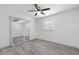 Bedroom with gray flooring, ceiling fan and mirrored closet doors at 1527 Hernandes Dr, Orlando, FL 32808