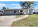 Gray house with a white door, small lawn, and walkway at 1527 Hernandes Dr, Orlando, FL 32808