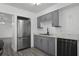 Gray cabinets, marble countertops and stainless steel appliances at 1527 Hernandes Dr, Orlando, FL 32808