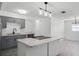 Modern kitchen with gray cabinets, marble countertops, and stainless steel appliances at 1527 Hernandes Dr, Orlando, FL 32808