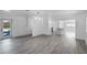 Open living room with gray flooring, view of kitchen and pool at 1527 Hernandes Dr, Orlando, FL 32808