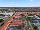 Aerial view of a community with red-tiled roofs next to a body of water at 1606 Sandy Point Sq # 53, Orlando, FL 32807