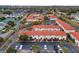 Aerial view of a community with red-tiled roofs, green landscaping, and parking at 1606 Sandy Point Sq # 53, Orlando, FL 32807