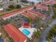 Aerial view of a community with a pool, spa, red-tiled roofs, and landscaping at 1606 Sandy Point Sq # 53, Orlando, FL 32807