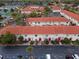 Aerial view of a community with red-tiled roofs, green landscaping, and parking at 1606 Sandy Point Sq # 53, Orlando, FL 32807