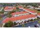 Aerial view of townhome community with well-maintained terracotta roofs, lush landscaping, and community pool at 1606 Sandy Point Sq # 53, Orlando, FL 32807