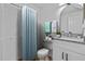 Bathroom featuring a vanity with a granite top, blue shower curtain and tile flooring at 1606 Sandy Point Sq # 53, Orlando, FL 32807