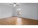 This is a bedroom featuring a ceiling fan, a window, and wood laminate flooring at 1606 Sandy Point Sq # 53, Orlando, FL 32807