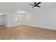 Dining room with wood floors, kitchen pass-through, and ceiling fan at 1606 Sandy Point Sq # 53, Orlando, FL 32807