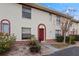 A townhouse facade featuring an arched entry, and garden creating a warm and inviting curb appeal at 1606 Sandy Point Sq # 53, Orlando, FL 32807
