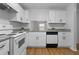 Bright kitchen featuring white cabinetry, granite countertops, and modern appliances at 1606 Sandy Point Sq # 53, Orlando, FL 32807