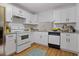 Bright kitchen featuring white cabinetry, granite countertops, and stainless steel appliances at 1606 Sandy Point Sq # 53, Orlando, FL 32807
