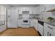 Updated kitchen with white cabinets and granite countertops at 1606 Sandy Point Sq # 53, Orlando, FL 32807