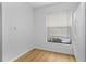 Bright laundry room with light wood flooring and a window at 1606 Sandy Point Sq # 53, Orlando, FL 32807