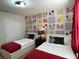 Mickey Mouse-themed bedroom with twin beds and red accents at 1721 Kona Ln, Davenport, FL 33897