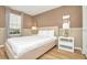 Cozy bedroom with a queen-size bed and wood floors at 1721 Kona Ln, Davenport, FL 33897