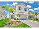 Two-story home with gray shutters, white siding, and a paved driveway at 1721 Kona Ln, Davenport, FL 33897
