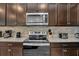 Stainless steel appliances and granite countertops in kitchen at 1721 Kona Ln, Davenport, FL 33897