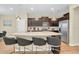 Modern kitchen island with seating and granite countertops at 1721 Kona Ln, Davenport, FL 33897