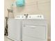 Bright laundry room with washer, dryer, and shelving at 1721 Kona Ln, Davenport, FL 33897