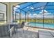 Covered patio with seating area overlooking the pool at 1721 Kona Ln, Davenport, FL 33897