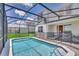 Screened pool and patio area with lounge chairs at 1721 Kona Ln, Davenport, FL 33897