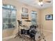 Bedroom featuring a drum set, ceiling fan, and large windows at 19106 Sheldon St, Orlando, FL 32833