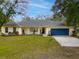 Ranch-style home with a large yard, and a two-car garage at 19106 Sheldon St, Orlando, FL 32833