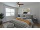 Spacious bedroom with large window, hardwood floors, and ceiling fan at 2232 Donahue Dr, Ocoee, FL 34761