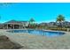 Community pool with a large patio area and palm trees at 2232 Donahue Dr, Ocoee, FL 34761