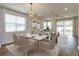 Open concept dining area with hardwood floors and modern light fixture at 2232 Donahue Dr, Ocoee, FL 34761