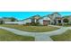 Landscaped corner lot with a one-story home and driveway at 2232 Donahue Dr, Ocoee, FL 34761