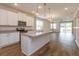 Open concept kitchen with white cabinets and an island at 2232 Donahue Dr, Ocoee, FL 34761
