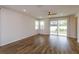 Bright living room with hardwood floors and sliding glass doors leading to backyard at 2232 Donahue Dr, Ocoee, FL 34761