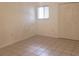 Simple bedroom with tile floors and a window with blinds at 257 Scottsdale Sq # 257, Winter Park, FL 32792