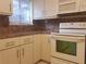 Kitchen features white appliances and light brown countertops at 257 Scottsdale Sq # 257, Winter Park, FL 32792