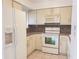Kitchen features white appliances and light brown countertops at 257 Scottsdale Sq # 257, Winter Park, FL 32792