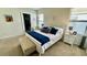 Well-lit bedroom with a queen-size bed and bench at 3033 Timber Hawk Cir, Ocoee, FL 34761