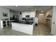 Modern kitchen with white cabinets, granite island, and stainless steel appliances at 3033 Timber Hawk Cir, Ocoee, FL 34761