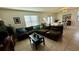 Spacious living room with a sectional sofa and view of dining area at 3033 Timber Hawk Cir, Ocoee, FL 34761