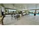 Covered patio area with tables near community pool at 3033 Timber Hawk Cir, Ocoee, FL 34761