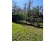 Grass yard with hedge and trees at 310 Blue Jacket Ln, Orlando, FL 32825