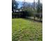 Grass yard with hedge and trees at 310 Blue Jacket Ln, Orlando, FL 32825