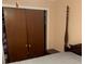 Bedroom with double doors and night stand at 310 Blue Jacket Ln, Orlando, FL 32825