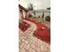 Charming home featuring a brick walkway and vibrant red mulch landscaping at 310 Blue Jacket Ln, Orlando, FL 32825